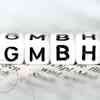 Vier Würfel mit den aufgedruckten Buchstaben "G-M-B-H".